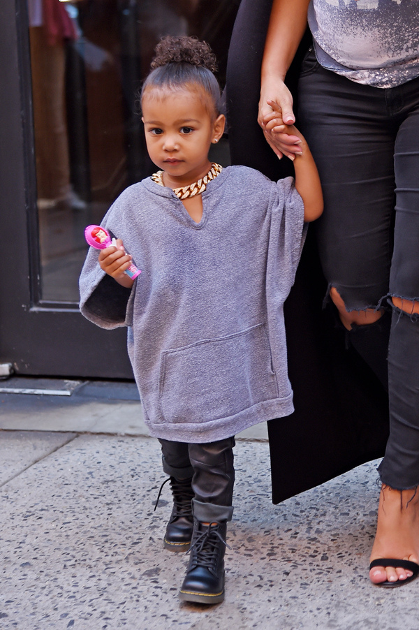 North West makes faces and licks the window at the Milk Studios as her and mom Kim Kardashian wait for their car, NYC Pictured: North West, Kim Kardashian Ref: SPL1119221 070915 Picture by: Splash News Splash News and Pictures Los Angeles:310-821-2666 New York:212-619-2666 London:870-934-2666 photodesk@splashnews.com 