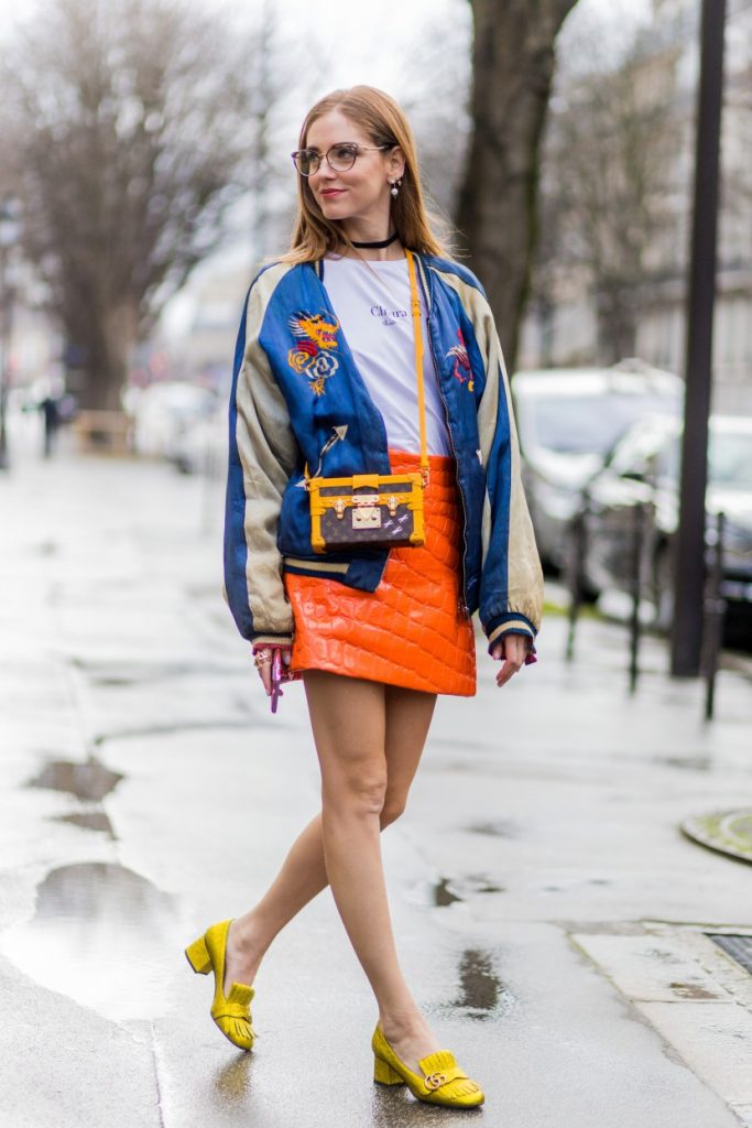 PARIS, FRANCE - March 07: Chiara Ferragni wearing golden Gucci shoes, orange Miu Miu skirt, Daily Mekong shirt, vintage jacket, Louis Vuitton bag, Bulgari sunglasses outside Giambattista Valli during the Paris Fashion Week Womenswear Fall/Winter 2016/2017 on March 7, 2016 in Paris, France. (Photo by Christian Vierig/Getty Images)