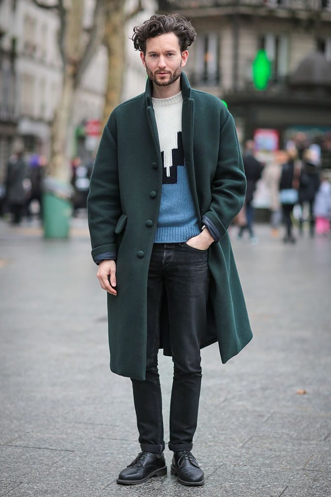 PARIS, FRANCE - JANUARY 23: Isaac Hindin-Miller (L) wearing a Z Zegna coat, a Maison Kitsune sweater, 3X1 jeans and Dr Martens shoes after the Etudes show during Paris Fashion Week Menswear Fall Winter 2016/2017 on January 23, 2016 in Paris, France. (Photo by Edward Berthelot/Getty Images)